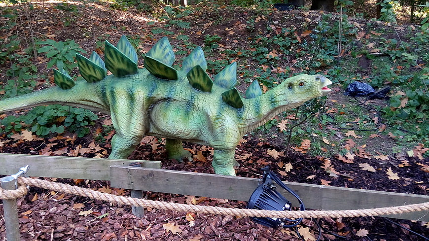Green Stegosaurus Dinosaur Statue in Outdoor Exhibit