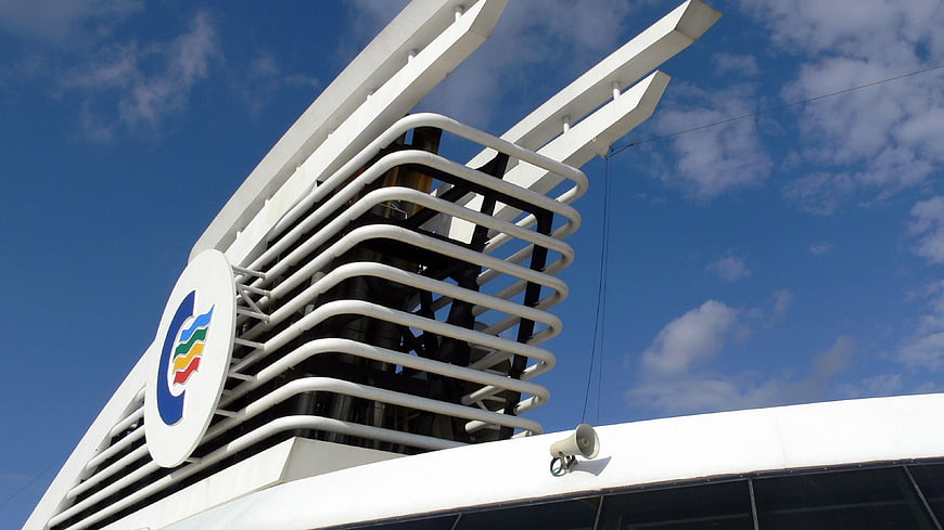 White ship funnel with colorful logo against blue sky