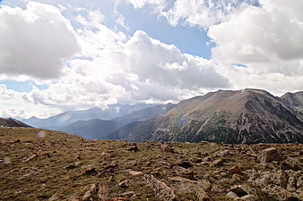 Rugged Rocky Mountain Landscape with Cloudy Sky