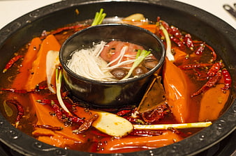 Spicy Sichuan Hot Pot With Noodles And Chili Peppers