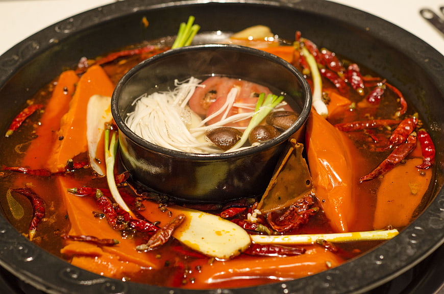 Spicy Sichuan Hot Pot With Noodles And Chili Peppers