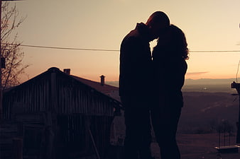 Silhouette of Romantic Couple Kissing at Sunset