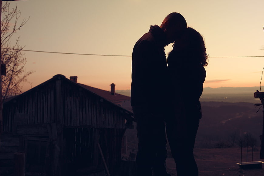 Silhouette of Romantic Couple Kissing at Sunset