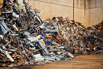 Large Pile of Scrap Metal and Industrial Waste in Junkyard