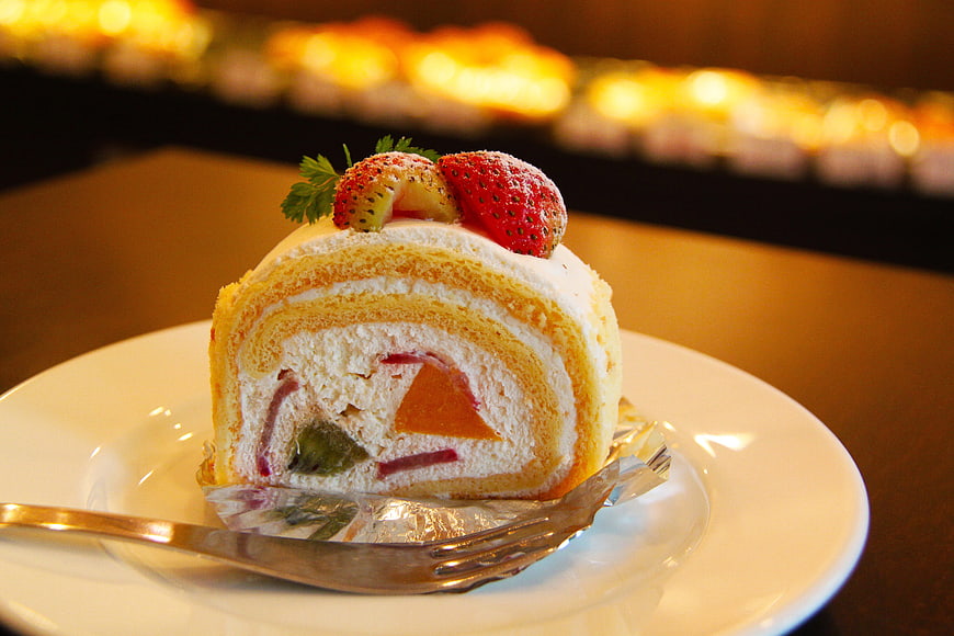 Strawberry Swiss Roll Cake Slice on White Plate