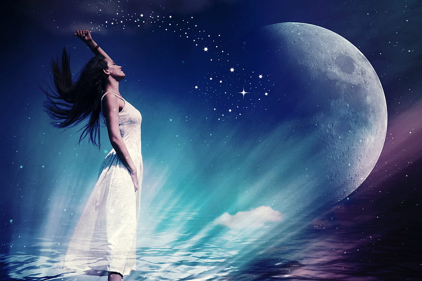 Woman in white dress reaching for stars under giant moon