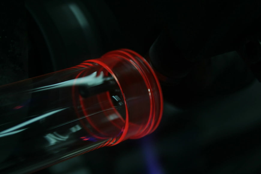 Close-up of red glass bottle neck with selective focus