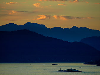 Serene Mountain Landscape at Sunset with Golden Sky