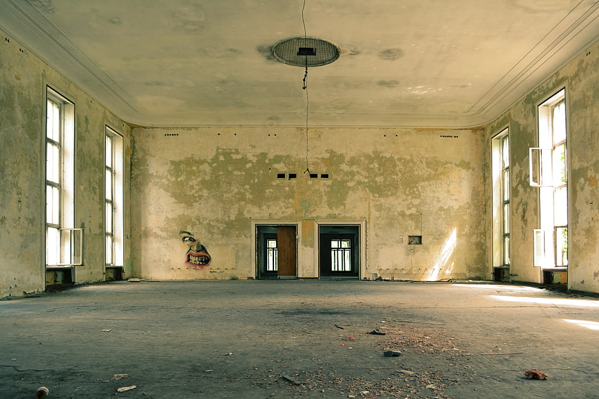 Abandoned Room with Peeling Walls and Graffiti