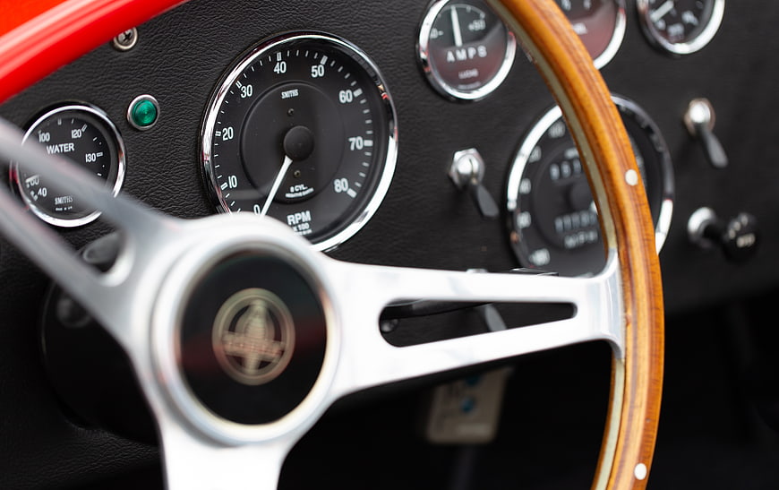 Vintage Car Dashboard with Wood Steering Wheel and Gauges