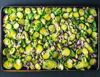 Top View Roasted Brussels Sprouts with Red Onion on Baking Sheet