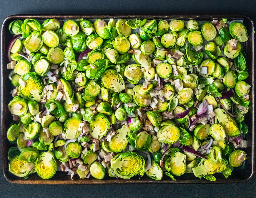 Top View Roasted Brussels Sprouts with Red Onion on Baking Sheet