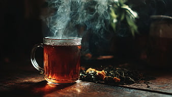 Steaming Hot Herbal Tea in Glass Mug on Wooden Table