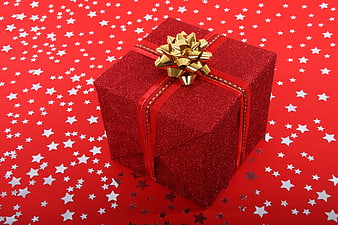 Red Glitter Christmas Gift Box With Gold Bow On Starry Background