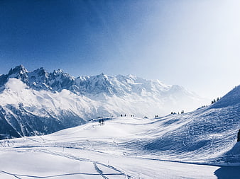 Majestic Snow-Covered Mountain Peaks Under Clear Blue Sky