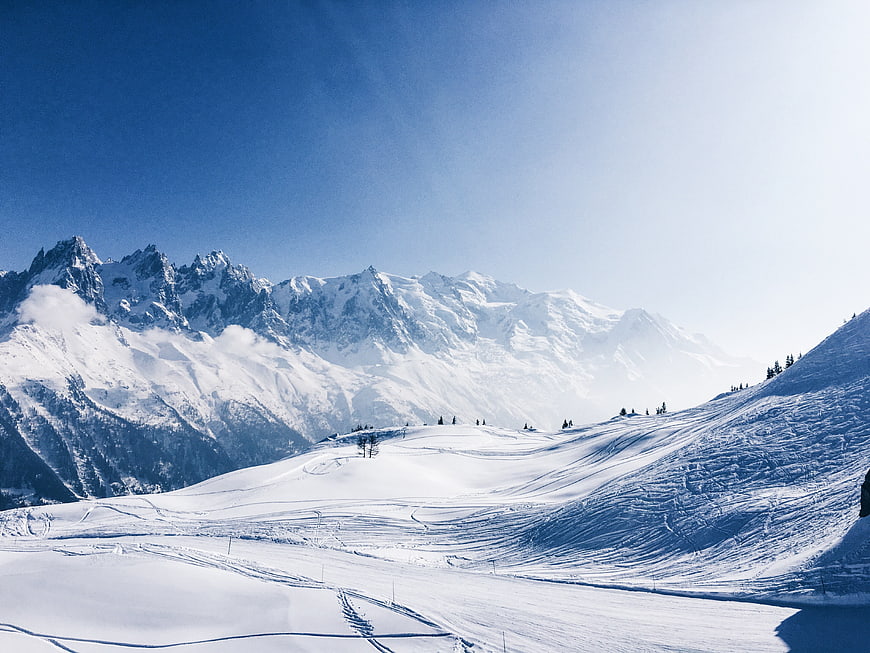Majestic Snow-Covered Mountain Peaks Under Clear Blue Sky