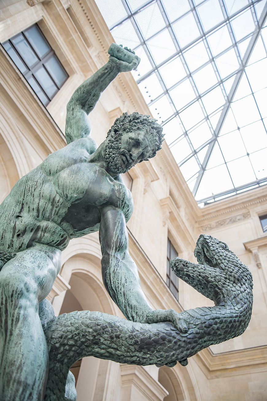 Low angle view of Hercules fighting snake bronze statue in Louvre museum