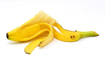 Peeled banana with yellow peel on white background
