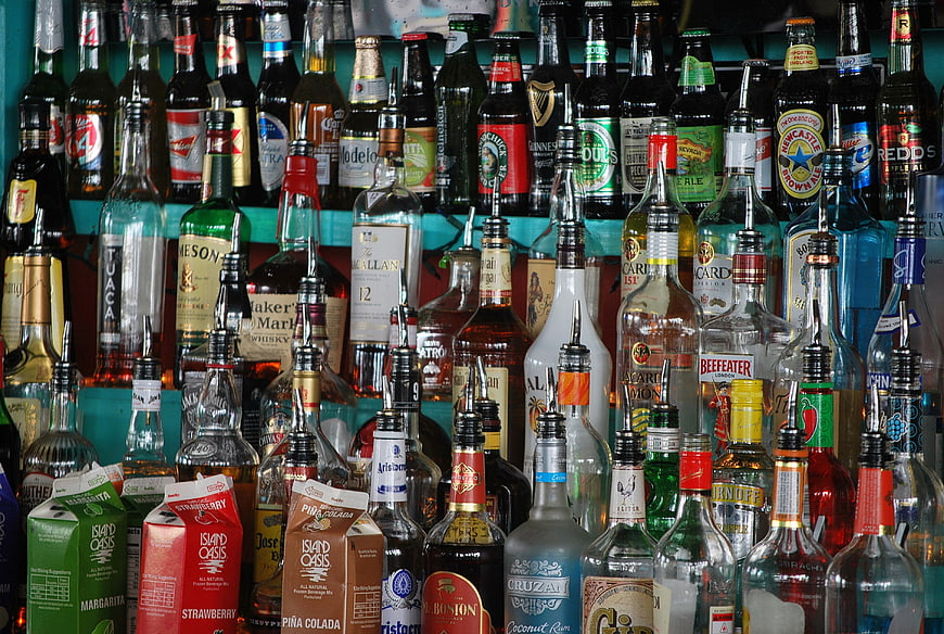 Colorful Bar Shelves Stocked With Assorted Liquor Bottles