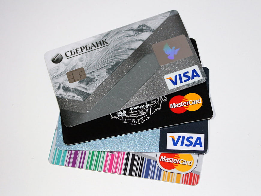 Stack of Visa and MasterCard credit cards on white background