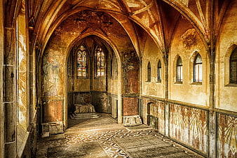 Interior of an abandoned medieval chapel with vaulted ceilings