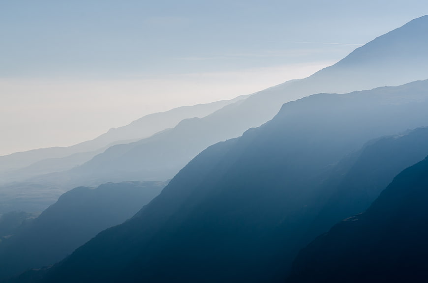 Atmospheric Blue Mountain Ranges in Misty Haze