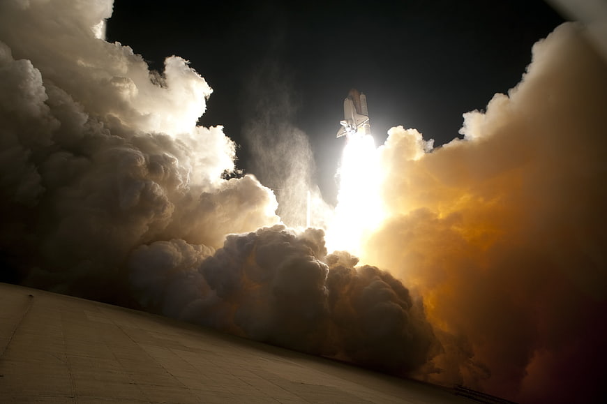 Space Shuttle Launch with Massive Smoke Plume at Night