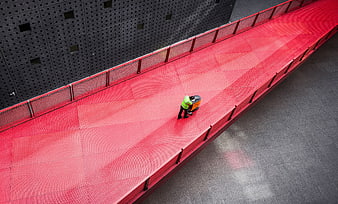 High angle view of worker cleaning red walkway