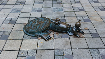 Bronze Crocodile Sculpture Emerging from Manhole Cover