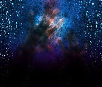 Scary ghostly hands pressing against cracked glass with water droplets