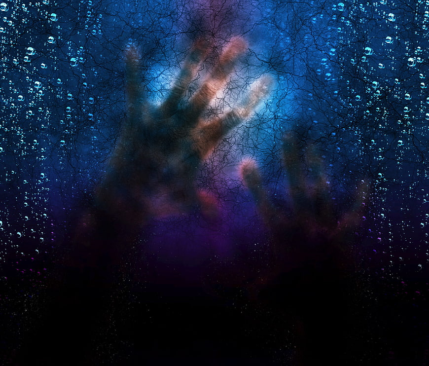 Scary ghostly hands pressing against cracked glass with water droplets