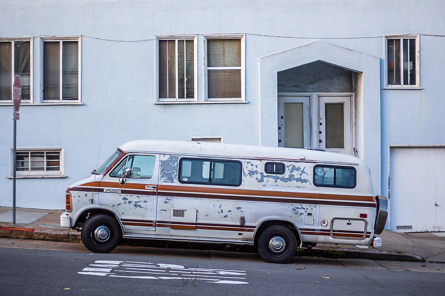 Vintage White RV Parked on Urban Street