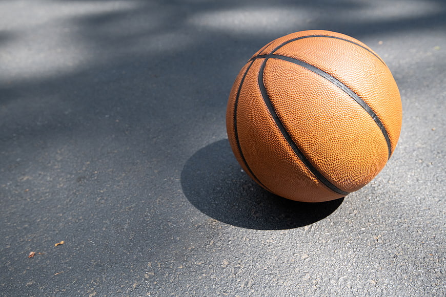 Orange Basketball on Asphalt Court with Copy Space