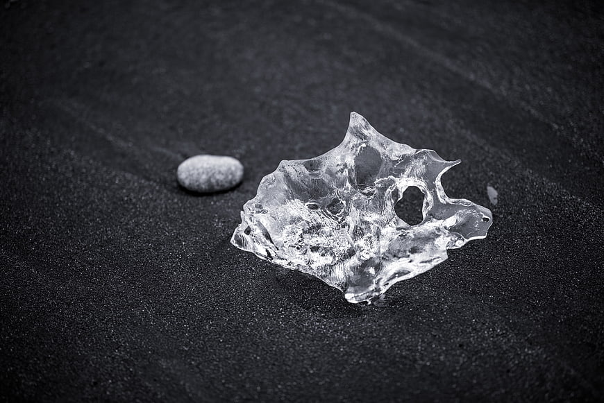 Crystal Clear Ice Shard on Black Sand Beach