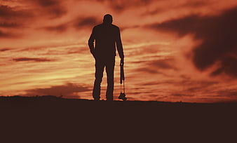 Silhouette of Photographer with Camera at Sunset