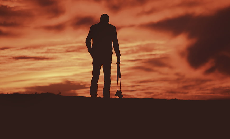 Silhouette of Photographer with Camera at Sunset