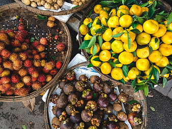 Top view of fresh tropical fruits in woven baskets