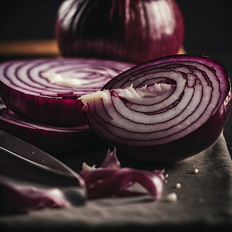 Close-up of sliced red onion with knife on dark surface