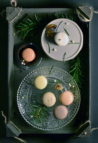 Festive macarons on vintage glass plate with pine branches