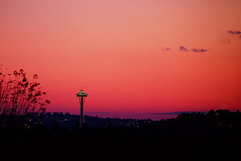 Space Needle Silhouette Against Vibrant Pink Sunset Sky