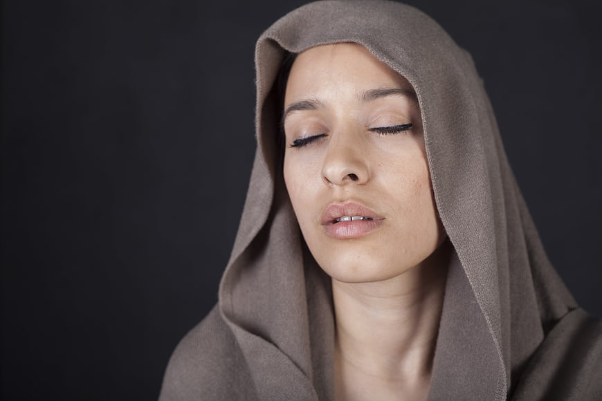 Serene Portrait of Young Woman Wearing Brown Hooded Scarf
