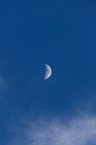Crescent Moon in Deep Blue Sky with Wispy Clouds