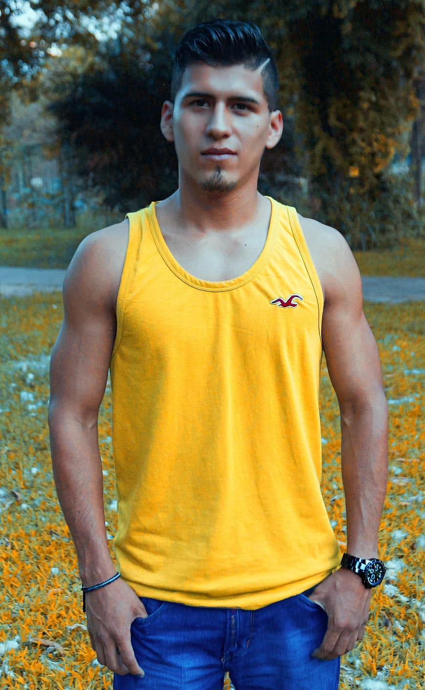 Portrait of Young Man in Yellow Tank Top Outdoors