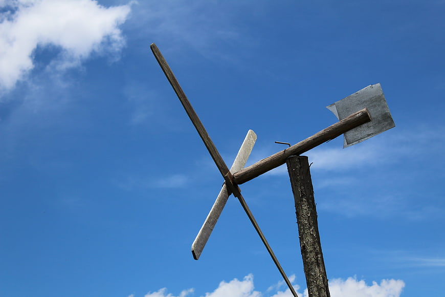 Rustic wooden windmill against blue sky