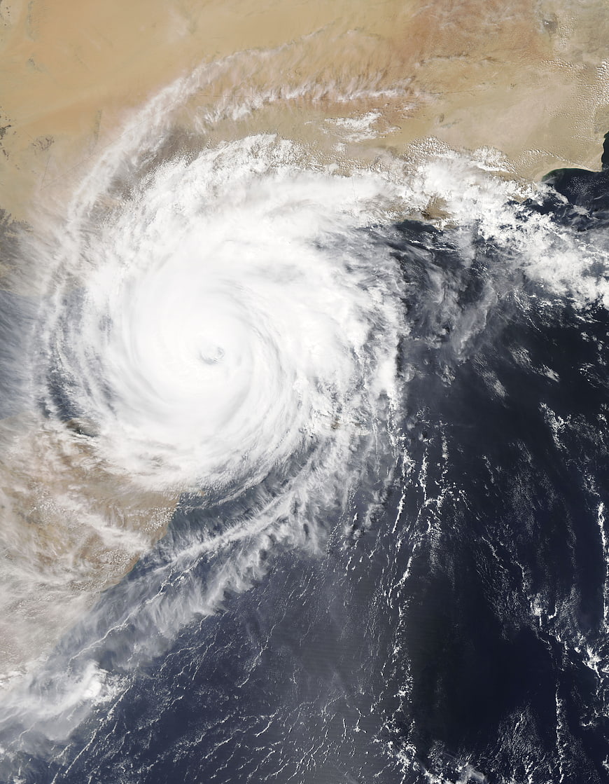 Satellite view of massive hurricane over ocean and desert