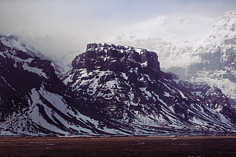 Dramatic Snow-Capped Mountain Peak in Winter Landscape