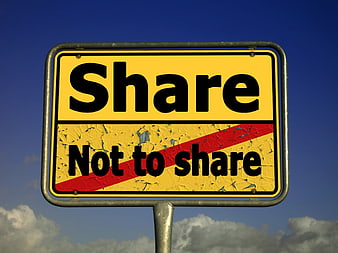 Yellow road sign with share and not to share text