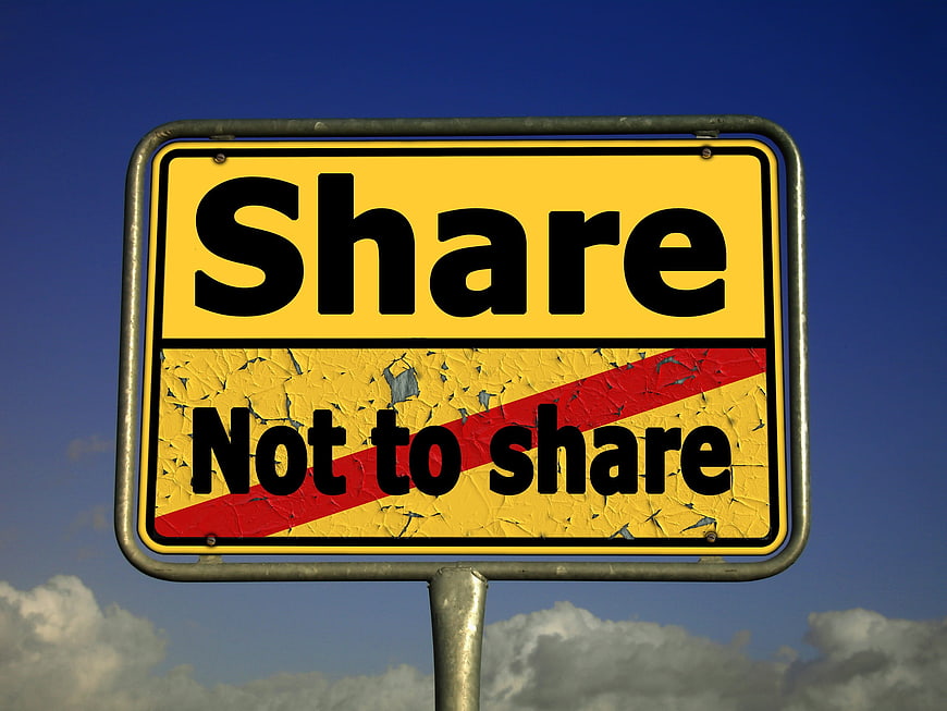 Yellow road sign with share and not to share text