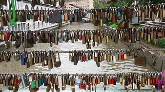 Love locks hanging on bridge cables over river in Ljubljana