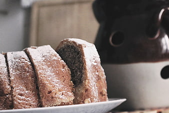 Sliced Bundt Cake with Powdered Sugar and Coffee Pot